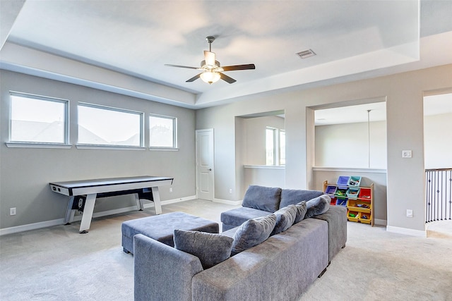 28606 Royal Pines Ct, Fulshear, TX 77441 - living room featuring ceiling fan, a tray ceiling, and light carpet