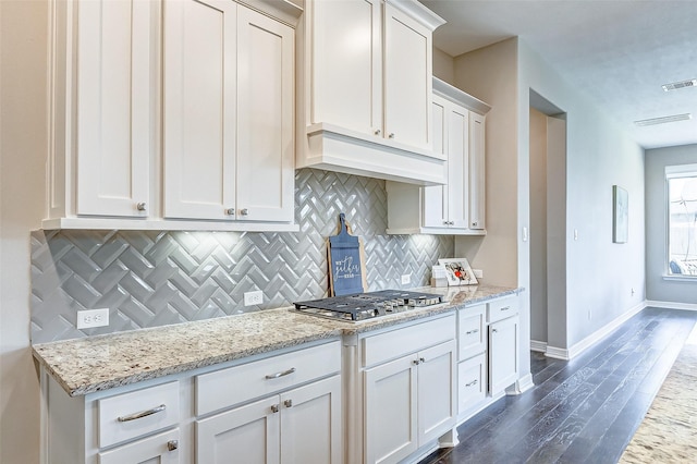 28606 Royal Pines Ct, Fulshear, TX 77441 - kitchen featuring stainless steel gas stovetop, tasteful backsplash, white cabinetry, and dark wood finished floors