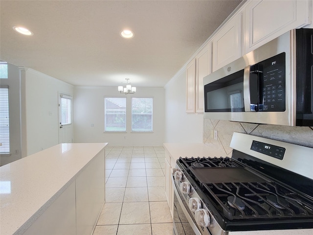 15311 Streetcar Ct, Cypress, TX 77429 - kitchen featuring stainless steel appliances, tasteful backsplash, a chandelier, light countertops, and white cabinets