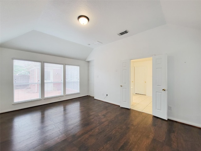 15311 Streetcar Ct, Cypress, TX 77429 - unfurnished room with vaulted ceiling and dark wood-type flooring