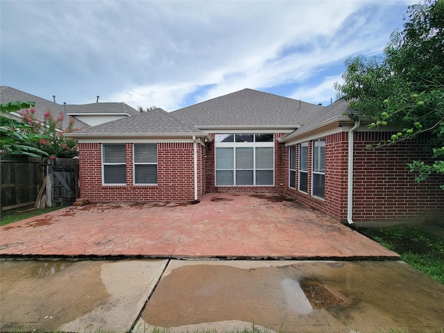 15311 Streetcar Ct, Cypress, TX 77429 - back of house with brick siding, a patio, and roof with shingles