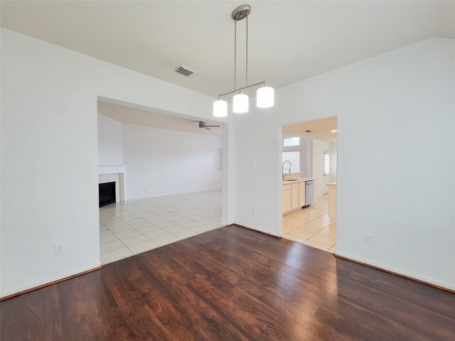 15311 Streetcar Ct, Cypress, TX 77429 - empty room with ceiling fan, light wood finished floors, and a fireplace