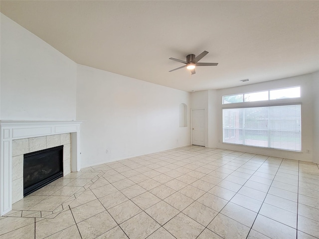 15311 Streetcar Ct, Cypress, TX 77429 - unfurnished living room with a ceiling fan, light tile patterned floors, a tiled fireplace, and arched walkways