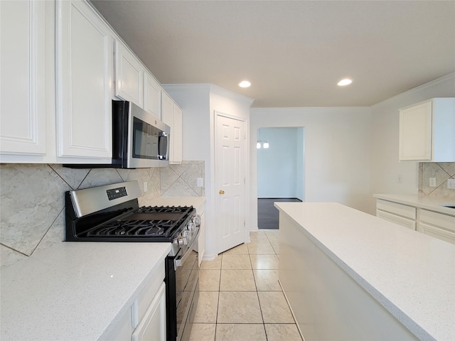 15311 Streetcar Ct, Cypress, TX 77429 - kitchen featuring stainless steel appliances, backsplash, white cabinetry, recessed lighting, and light tile patterned floors