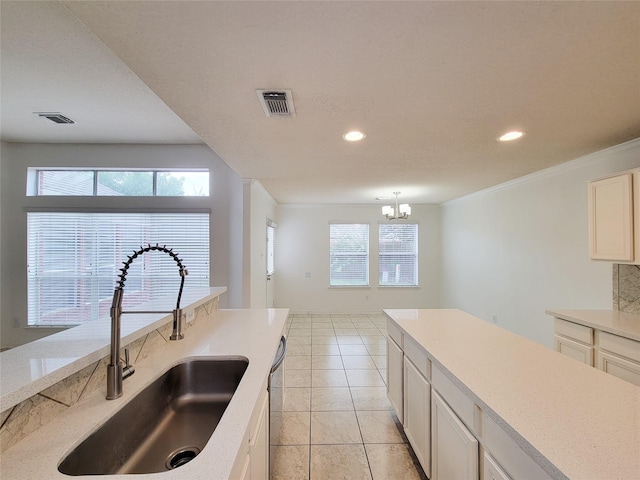 15311 Streetcar Ct, Cypress, TX 77429 - kitchen featuring recessed lighting, healthy amount of natural light, a chandelier, light tile patterned floors, and light countertops