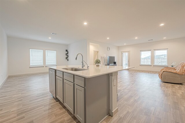 1815 Sandy Trail Ln, Rosenberg, TX 77469 - kitchen with gray cabinetry, open floor plan, light wood-style flooring, plenty of natural light, and recessed lighting