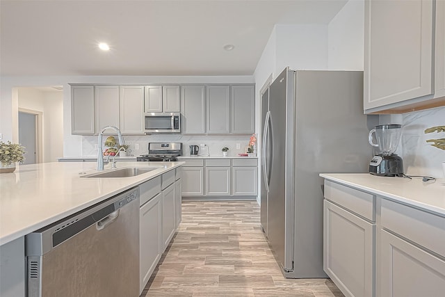 1815 Sandy Trail Ln, Rosenberg, TX 77469 - kitchen featuring stainless steel appliances, decorative backsplash, light countertops, light wood-style floors, and recessed lighting