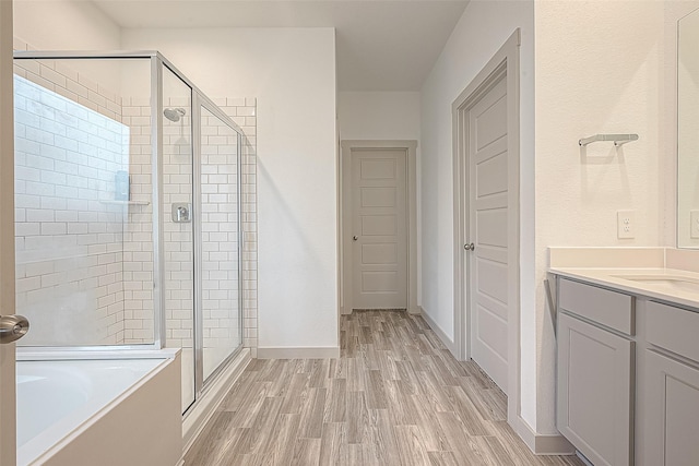 1815 Sandy Trail Ln, Rosenberg, TX 77469 - bathroom featuring a shower stall, a bath, wood finished floors, and vanity