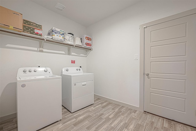 1815 Sandy Trail Ln, Rosenberg, TX 77469 - laundry area with separate washer and dryer and light wood finished floors