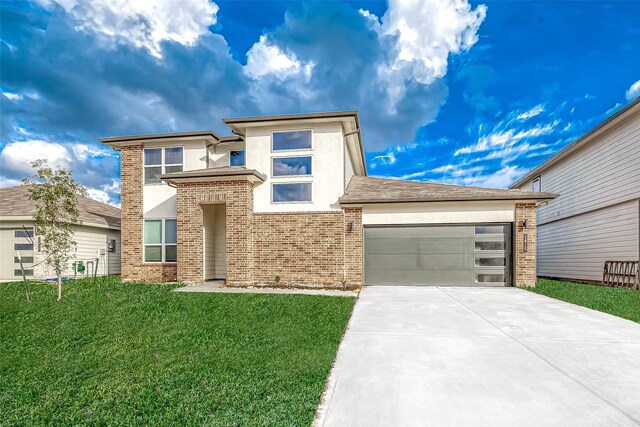 1815 Sandy Trail Ln, Rosenberg, TX 77469 - prairie-style home with driveway, an attached garage, a front yard, brick siding, and stucco siding
