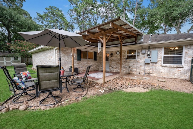 15638 Charolais Dr, Cypress, TX 77429 - back of house featuring a patio, a lawn, brick siding, a storage unit, and outdoor dining area