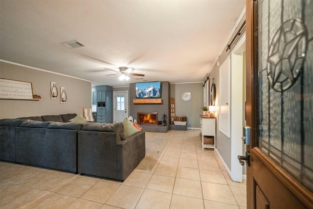 15638 Charolais Dr, Cypress, TX 77429 - living room with ceiling fan, light tile patterned floors, crown molding, and a brick fireplace