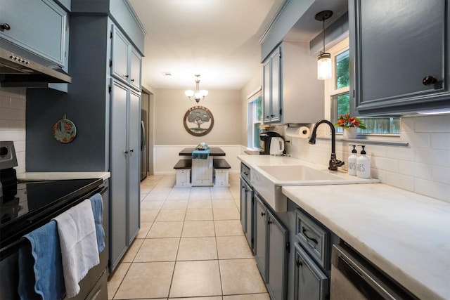 15638 Charolais Dr, Cypress, TX 77429 - kitchen featuring electric range, light countertops, a chandelier, ventilation hood, and decorative backsplash