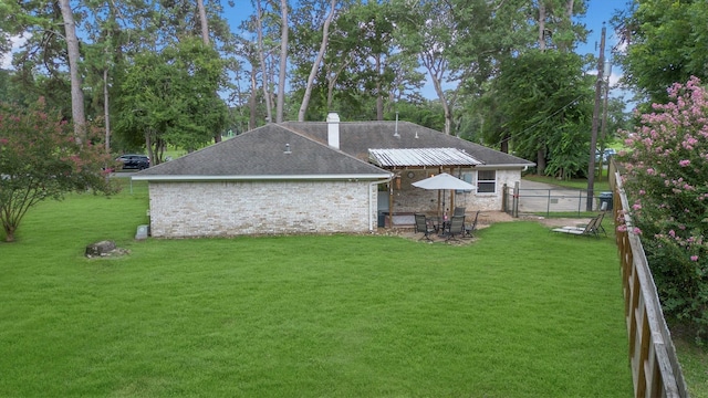 15638 Charolais Dr, Cypress, TX 77429 - back of house with a fenced backyard, roof with shingles, and a chimney