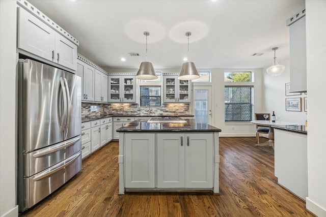 6410 Rodrigo St Unit B, Houston, TX 77007 - kitchen with freestanding refrigerator, backsplash, dark wood-type flooring, glass insert cabinets, and recessed lighting