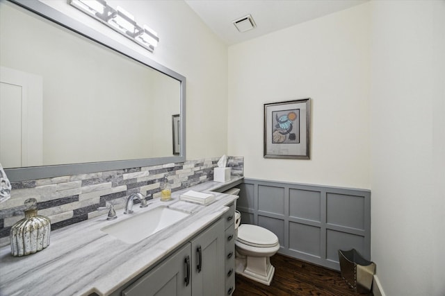 6410 Rodrigo St Unit B, Houston, TX 77007 - bathroom with vanity, wood finished floors, wainscoting, and a decorative wall