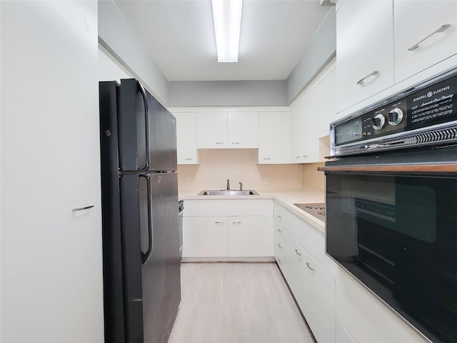 2600 Bellefontaine St Unit A21, Houston, TX 77025 - kitchen featuring black appliances, white cabinetry, and light countertops