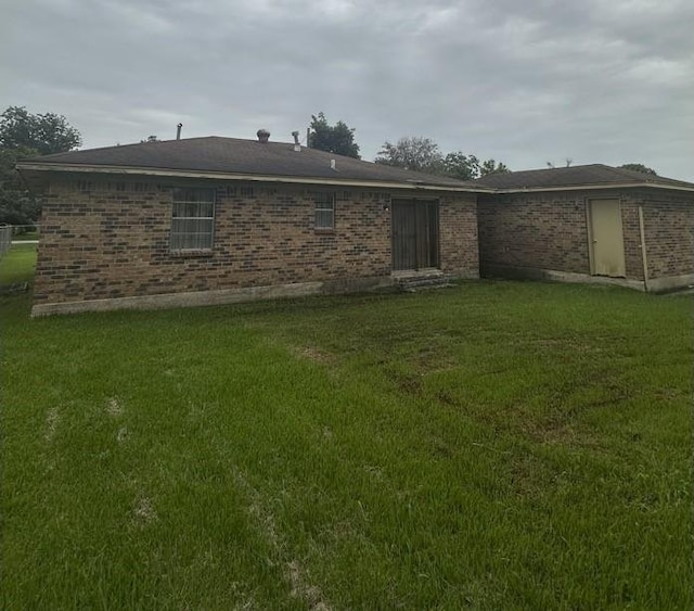 4625 Los Angeles St, Houston, TX 77026 - rear view of house with brick siding and a lawn