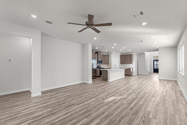 21521 Witham Promenade Ln, Magnolia, TX 77355 - unfurnished living room featuring light wood finished floors, a ceiling fan, and recessed lighting