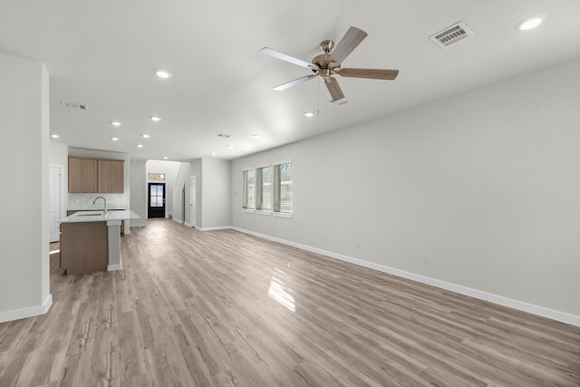 21521 Witham Promenade Ln, Magnolia, TX 77355 - unfurnished living room with recessed lighting, light wood-style floors, and ceiling fan