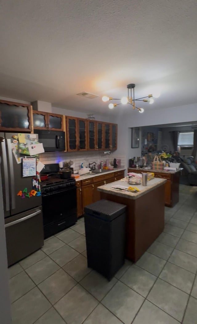 3201 Stallings Dr, Houston, TX 77088 - kitchen featuring black appliances, light tile patterned floors, a center island, a chandelier, and glass insert cabinets