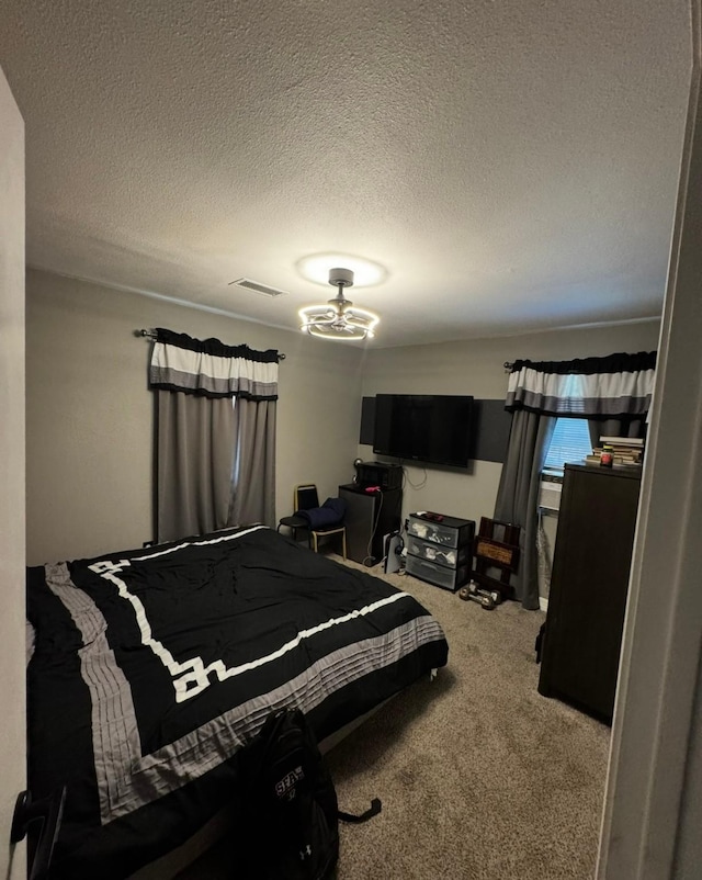 3201 Stallings Dr, Houston, TX 77088 - bedroom featuring carpet flooring, a textured ceiling, and a chandelier