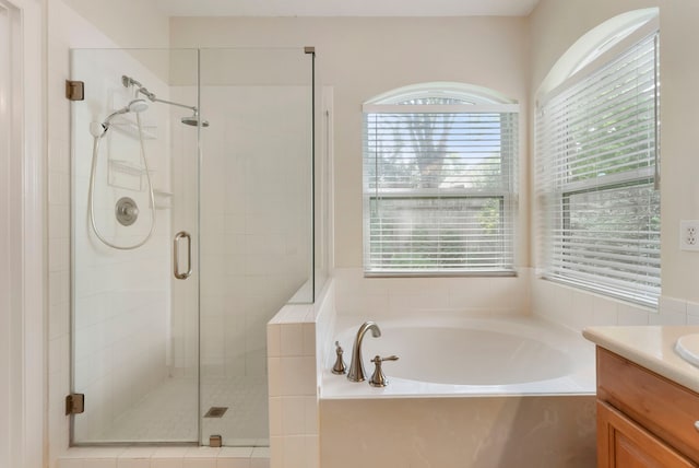 31 N Winterport Cir, The Woodlands, TX 77382 - bathroom featuring a bath, vanity, a stall shower, and plenty of natural light