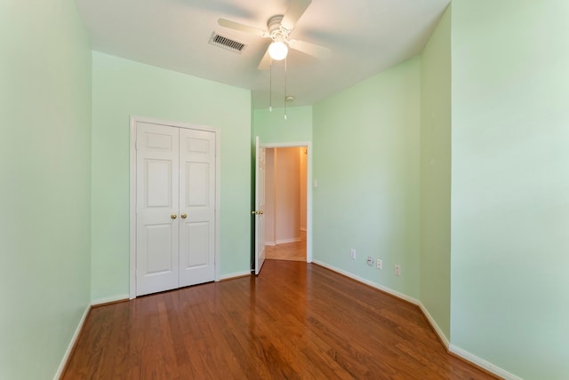 31 N Winterport Cir, The Woodlands, TX 77382 - unfurnished bedroom featuring wood finished floors, a closet, and ceiling fan