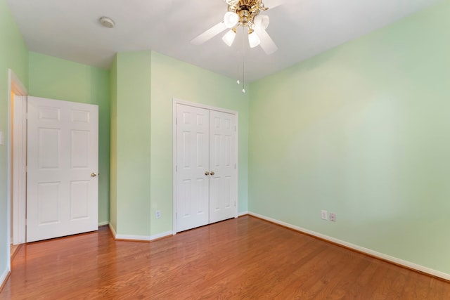 31 N Winterport Cir, The Woodlands, TX 77382 - unfurnished bedroom with wood finished floors, a closet, and ceiling fan