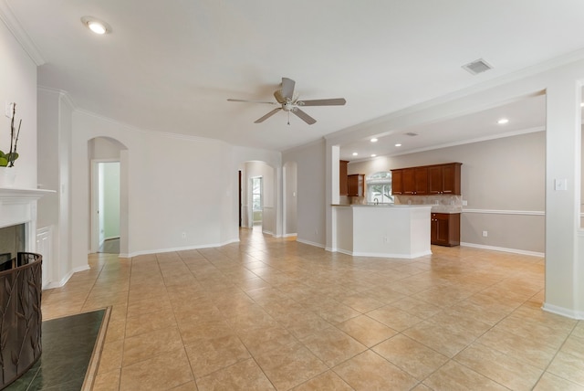 31 N Winterport Cir, The Woodlands, TX 77382 - unfurnished living room featuring arched walkways, a ceiling fan, light tile patterned flooring, crown molding, and recessed lighting