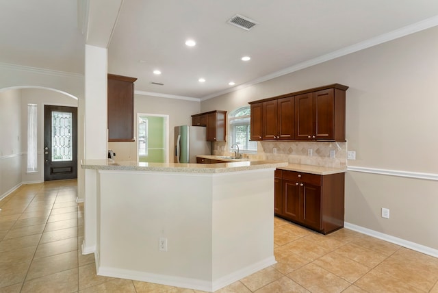 31 N Winterport Cir, The Woodlands, TX 77382 - kitchen with stainless steel fridge with ice dispenser, light tile patterned floors, ornamental molding, decorative backsplash, and recessed lighting