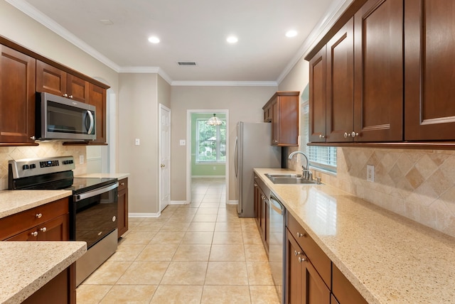 31 N Winterport Cir, The Woodlands, TX 77382 - kitchen with stainless steel appliances, backsplash, light stone countertops, crown molding, and light tile patterned floors