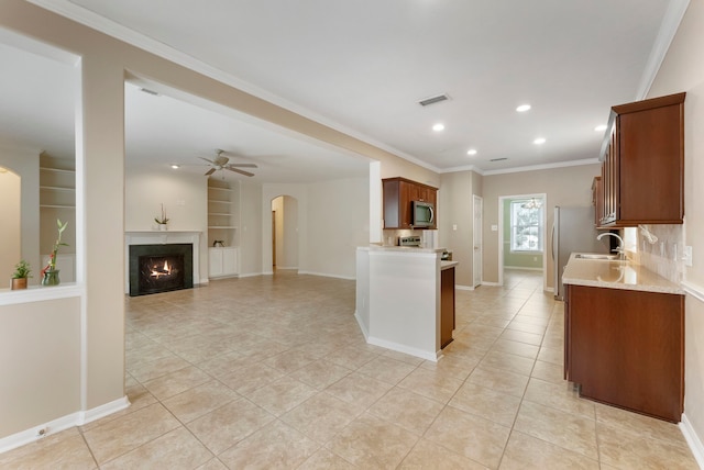 31 N Winterport Cir, The Woodlands, TX 77382 - kitchen with stainless steel appliances, light tile patterned floors, arched walkways, ceiling fan, and recessed lighting