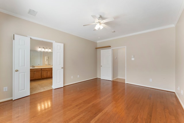 31 N Winterport Cir, The Woodlands, TX 77382 - unfurnished bedroom featuring crown molding, light wood-type flooring, ensuite bathroom, and ceiling fan