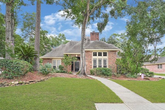 2814 Rustic Woods Dr, Houston, TX 77345 - view of front of house with a chimney, a front lawn, brick siding, and roof with shingles