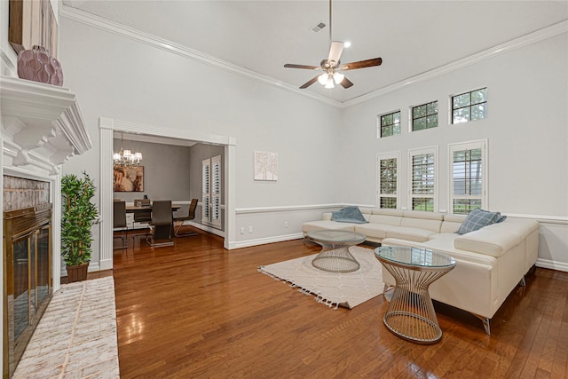 2814 Rustic Woods Dr, Houston, TX 77345 - living room featuring ornamental molding, wood-type flooring, a brick fireplace, ceiling fan, and a towering ceiling