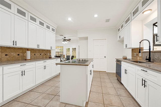 2814 Rustic Woods Dr, Houston, TX 77345 - kitchen with a kitchen island, black electric cooktop, tasteful backsplash, recessed lighting, and ceiling fan