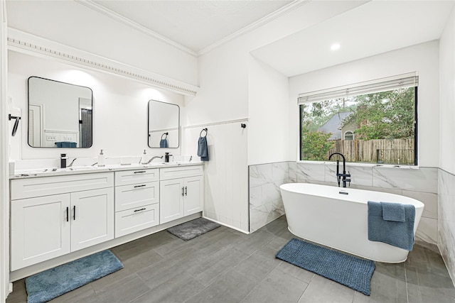 2814 Rustic Woods Dr, Houston, TX 77345 - full bathroom with tile walls, double vanity, a freestanding bath, ornamental molding, and a wainscoted wall