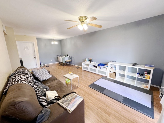 3075 Walnut Bend Ln Unit 36, Houston, TX 77042 - living room with wood finished floors, ceiling fan, and a chandelier