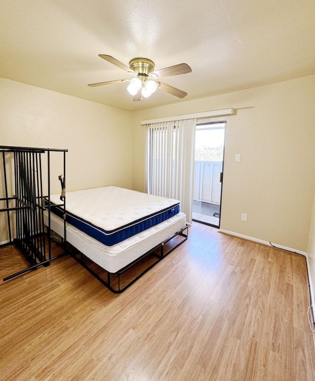 3075 Walnut Bend Ln Unit 36, Houston, TX 77042 - bedroom featuring light wood-style floors, access to exterior, and a ceiling fan