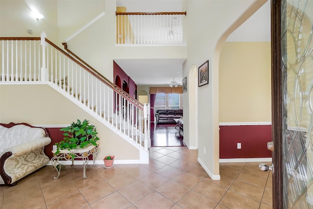 3705 Canterbury Park Dr, Pearland, TX 77584 - foyer with arched walkways, light tile patterned floors, a high ceiling, and stairway