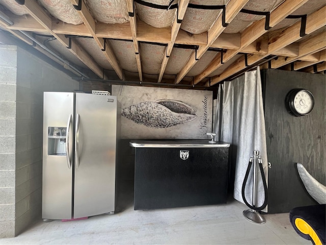 6625 Morris, Galveston, TX 77551 - detailed view of stainless steel fridge with ice dispenser and concrete block wall