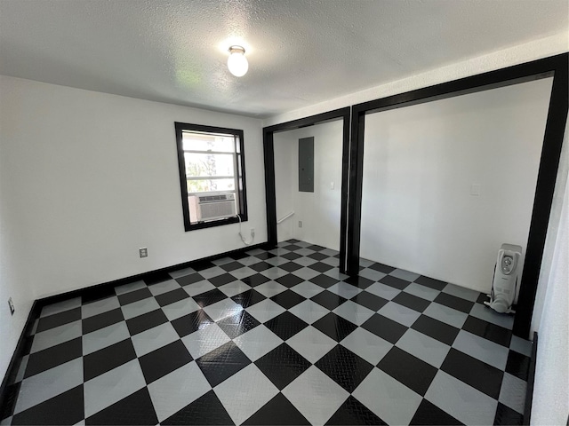6625 Morris, Galveston, TX 77551 - unfurnished bedroom with electric panel, a textured ceiling, and cooling unit