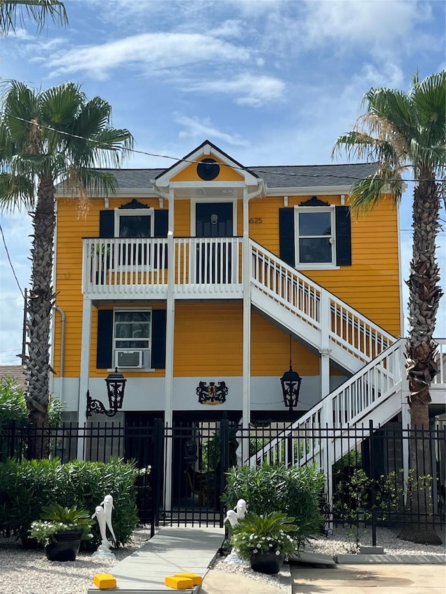 6625 Morris, Galveston, TX 77551 - view of property featuring stairs, a fenced front yard, and cooling unit