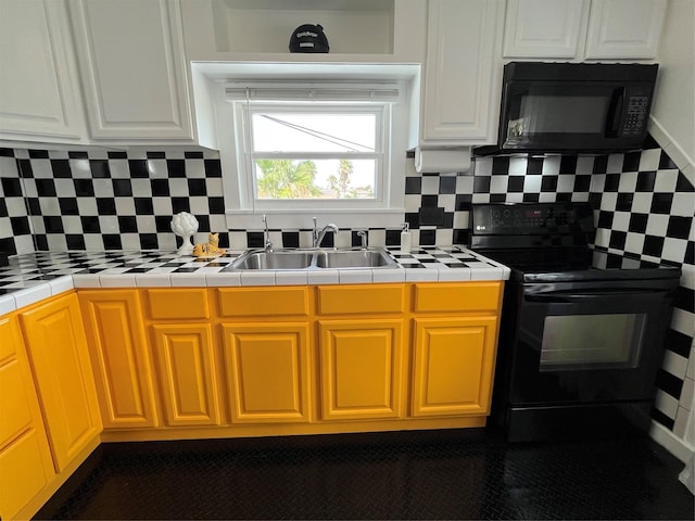 6625 Morris, Galveston, TX 77551 - kitchen featuring black appliances, tasteful backsplash, tile counters, and white cabinetry