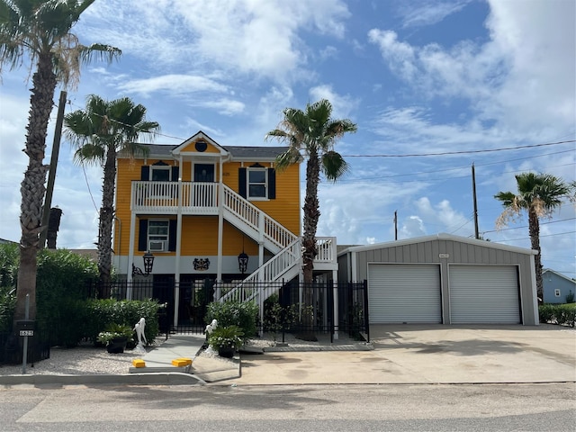 6625 Morris, Galveston, TX 77551 - view of front of property featuring an outbuilding, stairway, and a garage
