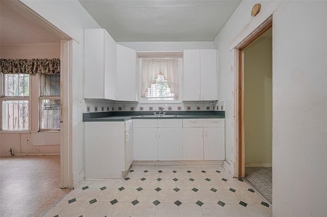 512 Threlkeld St, Houston, TX 77007 - kitchen with plenty of natural light, white cabinetry, light flooring, and dark countertops