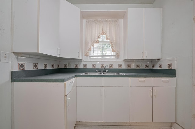 512 Threlkeld St, Houston, TX 77007 - kitchen featuring tasteful backsplash, dark countertops, and white cabinetry