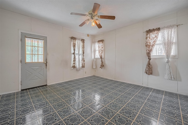 512 Threlkeld St, Houston, TX 77007 - empty room with healthy amount of natural light, a ceiling fan, tile patterned floors, and a textured ceiling
