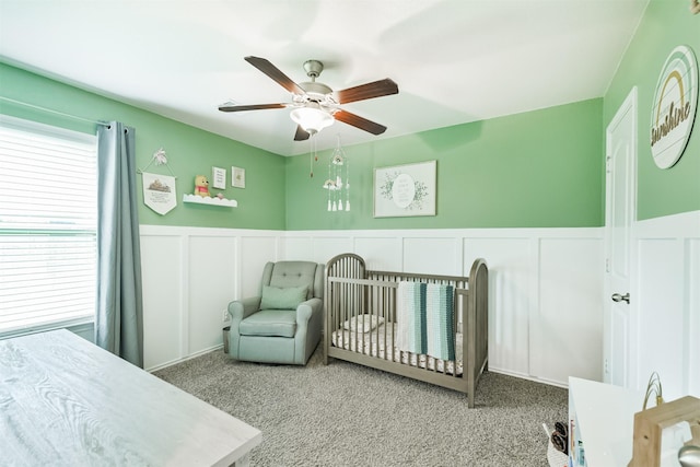 24218 Birchwood Creek Ct, Spring, TX 77389 - bedroom with a decorative wall, carpet floors, a nursery area, wainscoting, and a ceiling fan
